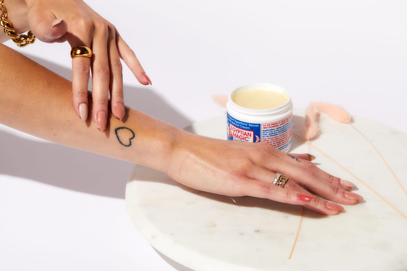 Cream being applied to a tattooed arm